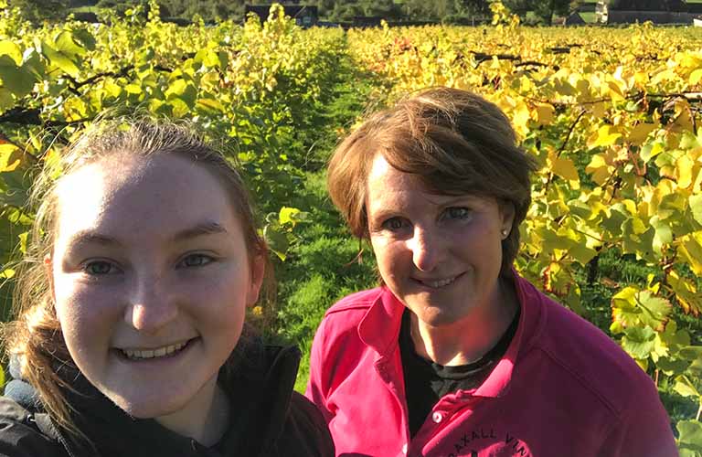 Lexa with her daughter amid the vines at Wraxall Vineyard in Somerset